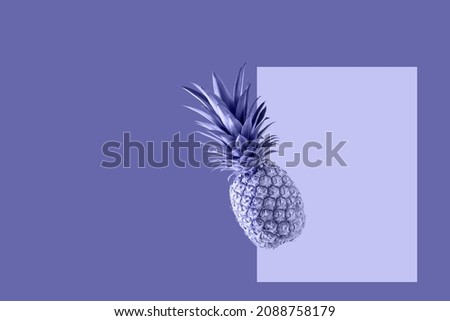 Fresh juicy tropical fruit pineapple flying isolated on violet background. Single whole pineapple falling. Creative card in trendy color 2022 Very Peri.