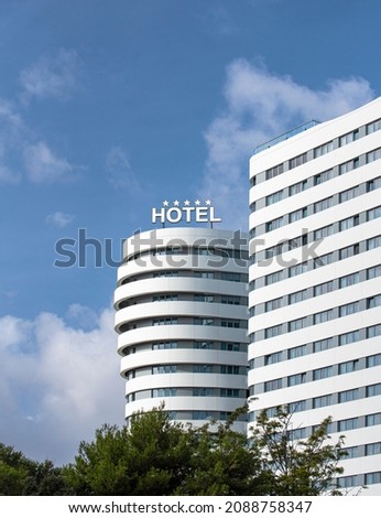 Facade of modern 5 star hotel in the city center in bright sunny day Royalty-Free Stock Photo #2088758347