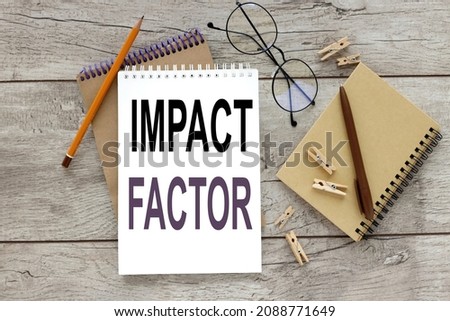 IMPACT FACTOR. notebook on a wooden table