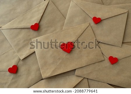 Valentine's day. Envelopes with red hearts. The holiday is February 14. Love letters in kraft paper envelopes with red hearts. Happy Valentine's Day greeting cards