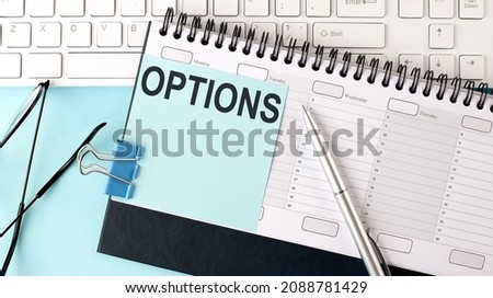 OPTIONS text on blue sticker on the planning and keyboard,blue background
