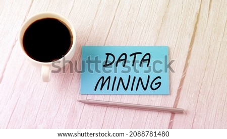 DATA MINING text on blue sticker with cofee and pen