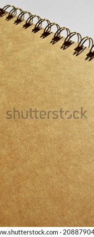 Wire spiral unlined clean beige and yellow cardboard isolated on white background