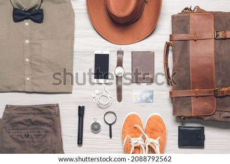 Set of travel accessories for men on wooden background