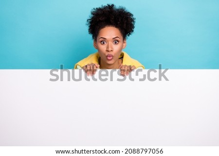 Photo of young pretty african girl impressed banner information pouted lips isolated over blue color background