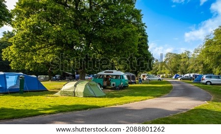 Camper vans and tents pitched at Cobleland Campsite during the summer in Trossachs National Park, Scotland Royalty-Free Stock Photo #2088801262