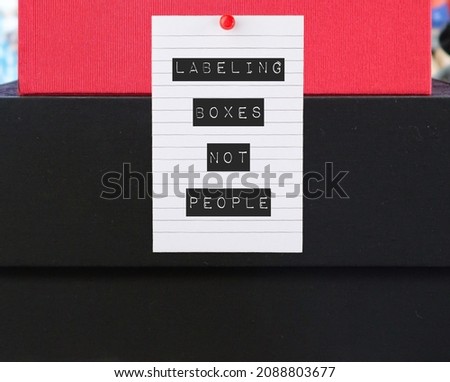 Boxes with pinned note written LABELING BOXES NOT PEOPLE , concept of avoid blaming or judging people and better understand them, stop labeling someone else on your problem Royalty-Free Stock Photo #2088803677