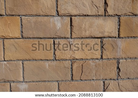 Yellowish brown surface of brick veneer wall (front view)