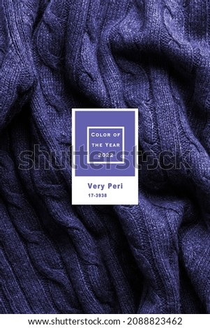Handmade lilac knitting wool texture background. New 2022 trending PANTONE 17-3938 Very Peri color