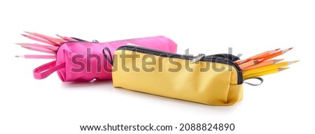 Cases with colorful pencils on white background
