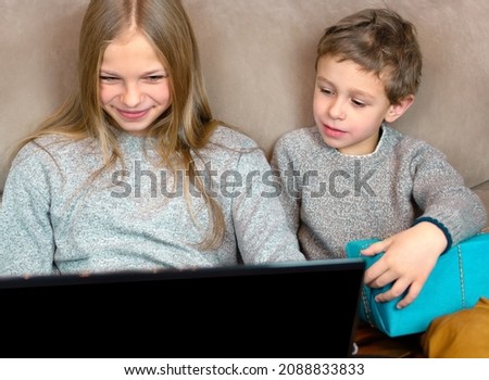 Girl and a boy communicate on a laptop online. They show gifts. Online Birthday Concept