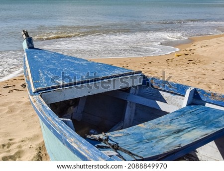 Close up of a traditional Puerto Rican fishing boat on a sand beach with surf. Royalty-Free Stock Photo #2088849970