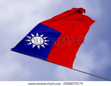 Taiwan's flag is isolated on a sky background. flag symbols of Taiwan. close up of a Taiwanese flag waving in the wind.
