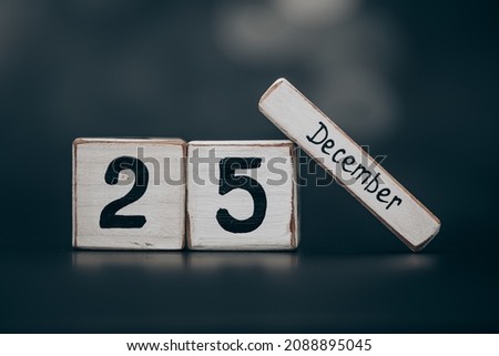 25 of december Image of december wooden color calendar dark background. empty space for text.