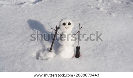 Snow man. Happy snowman on snow, funny winter time. Repairman with wrench and screwdriver. Support repair and recover service.
