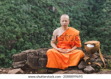 Monk meditating on top of a mountain,Purify the mind, Religious concept. Royalty-Free Stock Photo #2088899695
