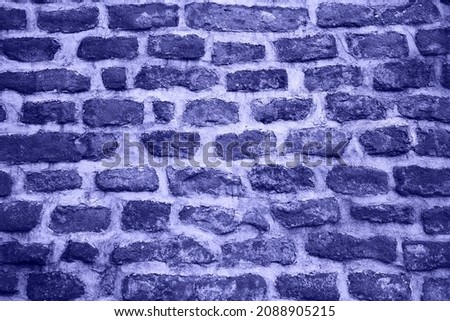 Background of stone and brick wall texture. Color of 2022 year, very peri, toned