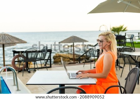 casual woman relaxing with a laptop on vacation