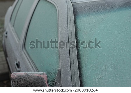 Car covered with ice and icicles after freezing rain. ice storm