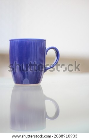  a blue cup of coffee on the table