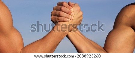 Vs. People, leisure, challenge. Rivalry concept - close up of male friends arm wrestling. Leadership concept.