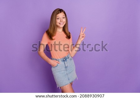 Portrait of attractive cheerful cute girl showing v-sign good mood copy space isolated over bright violet purple color background