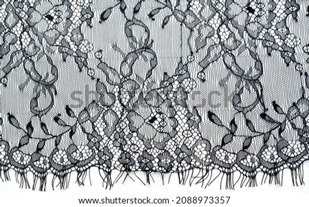 Black lace on a white background. Lace black drawing with flowers on a white background. Texture. pattern
