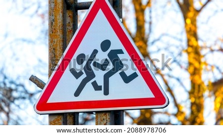 Red and white pedestrian crossing road sign for children
