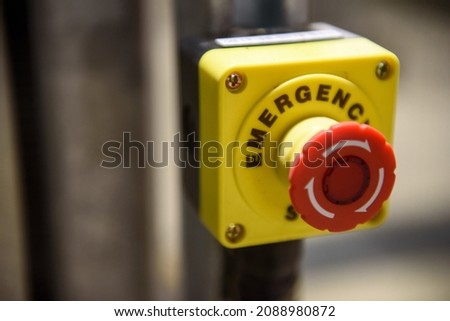 Red emergency stop button close-up