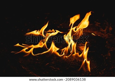 Flames of fire burning on the ground Royalty-Free Stock Photo #2089036138