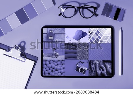 Workplace with Tablet, coffee and New 2022 trending PANTONE 17-3938 Very Peri color