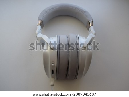 White headset or headphones with wire cable on white background for high technology for professional digital volume sound vibes for gaming and music industry