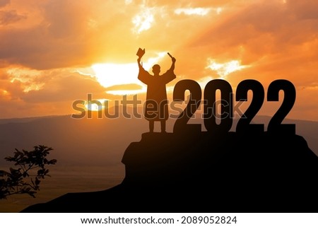 Silhouette Young man Graduation in 2022 years, education congratulation concept , Freedom and Happy new year, copy space. Royalty-Free Stock Photo #2089052824