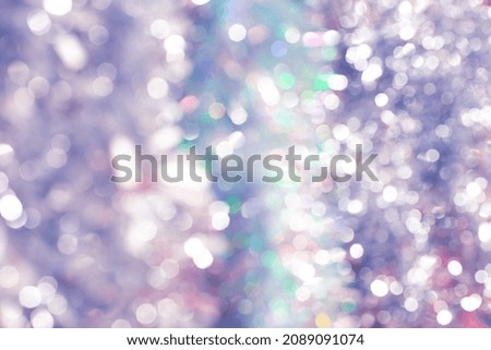 Glitter and bokeh of silver tinsel. Festive Christmas background.