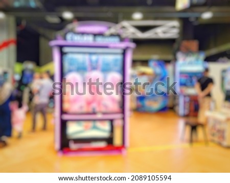 Defocused abstract background of arcade game machine zone. Bokeh image of the game area for background usage with vintage tone