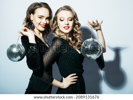 Two Party women in black dress with disco balls