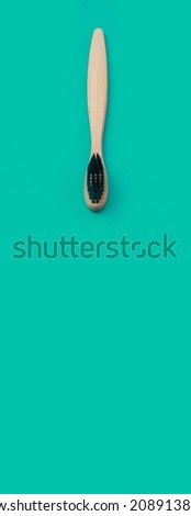 wooden toothbrush on a green panoramic background
