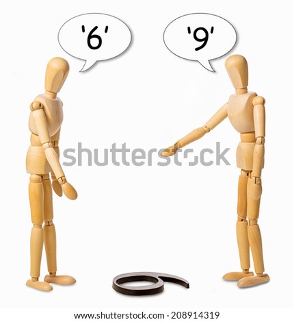 two manikins arguing whether a number on the floor is a 6 or a 9 Royalty-Free Stock Photo #208914319