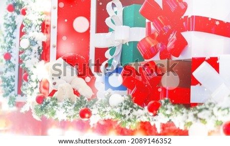Blurred creative christmas background  with gifts presents boxes and Teddy Bear in Santa Claus Hat in Market. Decorative abstract Effects