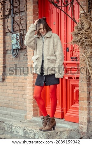 Young woman walking on the street in autumn or winter in old city scenery