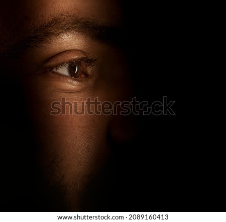 eyes hidden in darkness  . spying concept Royalty-Free Stock Photo #2089160413