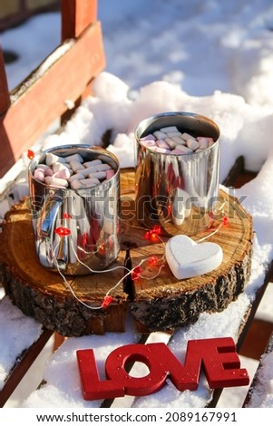 Valentine's Day, the word "love" in the snow, coffee for two