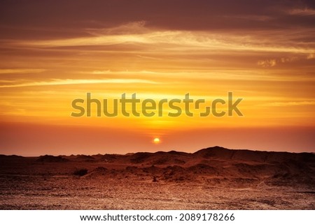 An image of a sunset in the egypt desert