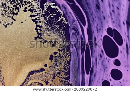 Fluid Art. Golden metallic abstraction and purple waves. Marble effect background or texture