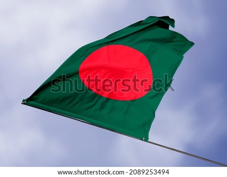 Bangladesh's flag is isolated on a sky background. flag symbols of Bangladesh. close up of a Bangladeshi flag waving in the wind.