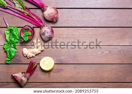 Red Beetroot, ginger and lemon smoothie on wooden Background. homemade detox drinks