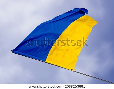 Ukraine's flag is isolated on a sky background. flag symbols of Ukraine. close up of a Ukrainian flag waving in the wind.