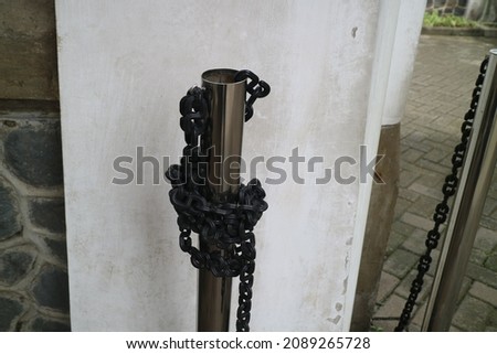 plastic chain wrapped around an iron pipe photo