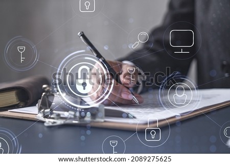African American businesswoman in formal wear signing the contract to prevent probability of risks in cyber security. Padlock Hologram icons over the working desk. Women in business concept.