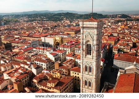 High view from Santa Maria del Fiore cathedral with a wide view of the Giotto's Bell Tower and the city of Firenze, Tuscany, Italy.